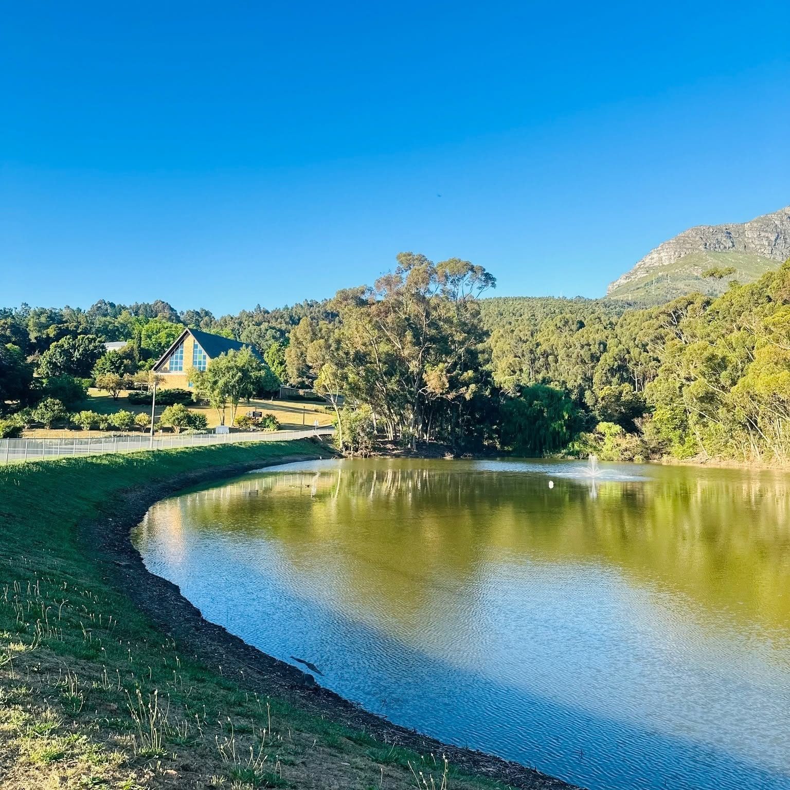 The campus dam, with the mountain rising beyond the far bank